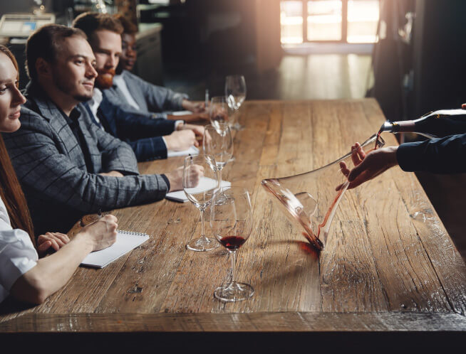 Four people tasting wines in a store