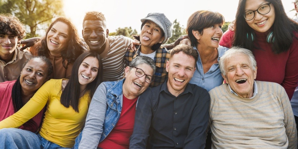 A diverse group of US citizens, representing the age and cultural scope of diversity in DMV and tax collector service users.