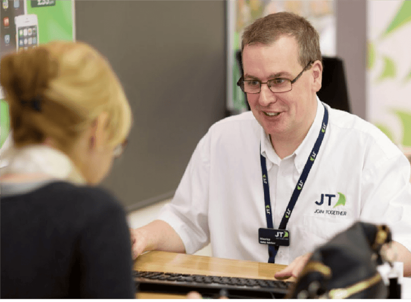 caucasian male talking to a caucasian women customer, he is with a Jersey Telecom uniform