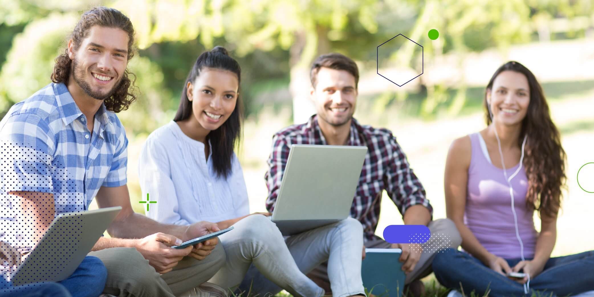 Five university students using their electronic devices sitting in a park