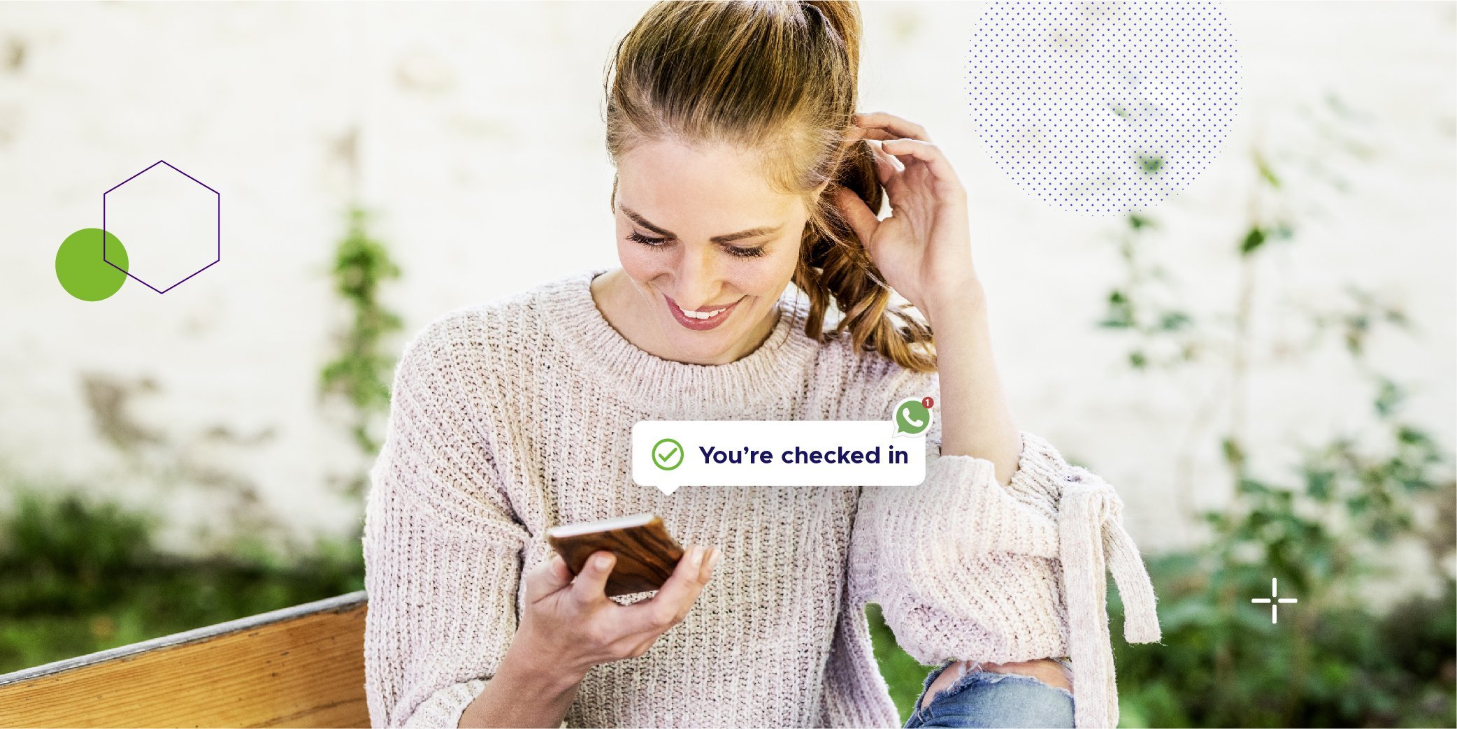 Woman sitting on a bench reading her message notified by whatsapp that she is registered