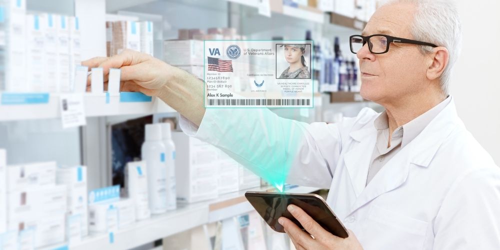 Pharmacist checks Veteran ID to fill prescription