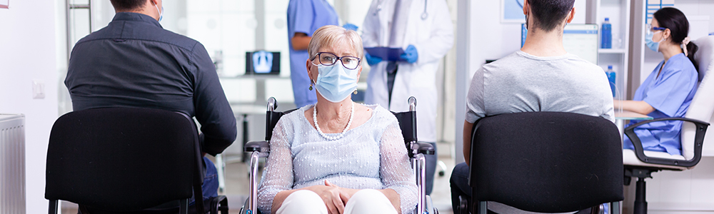 Elder women in a wheelchair waiting in an hospital waiting room