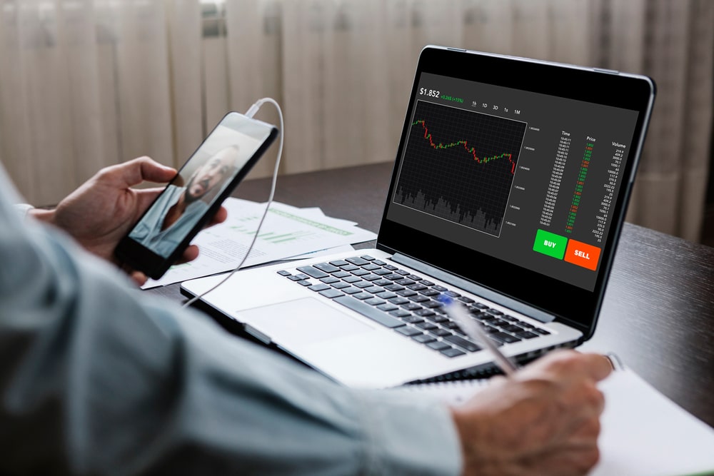 Customer on video call with bank employee while reviewing financial charts