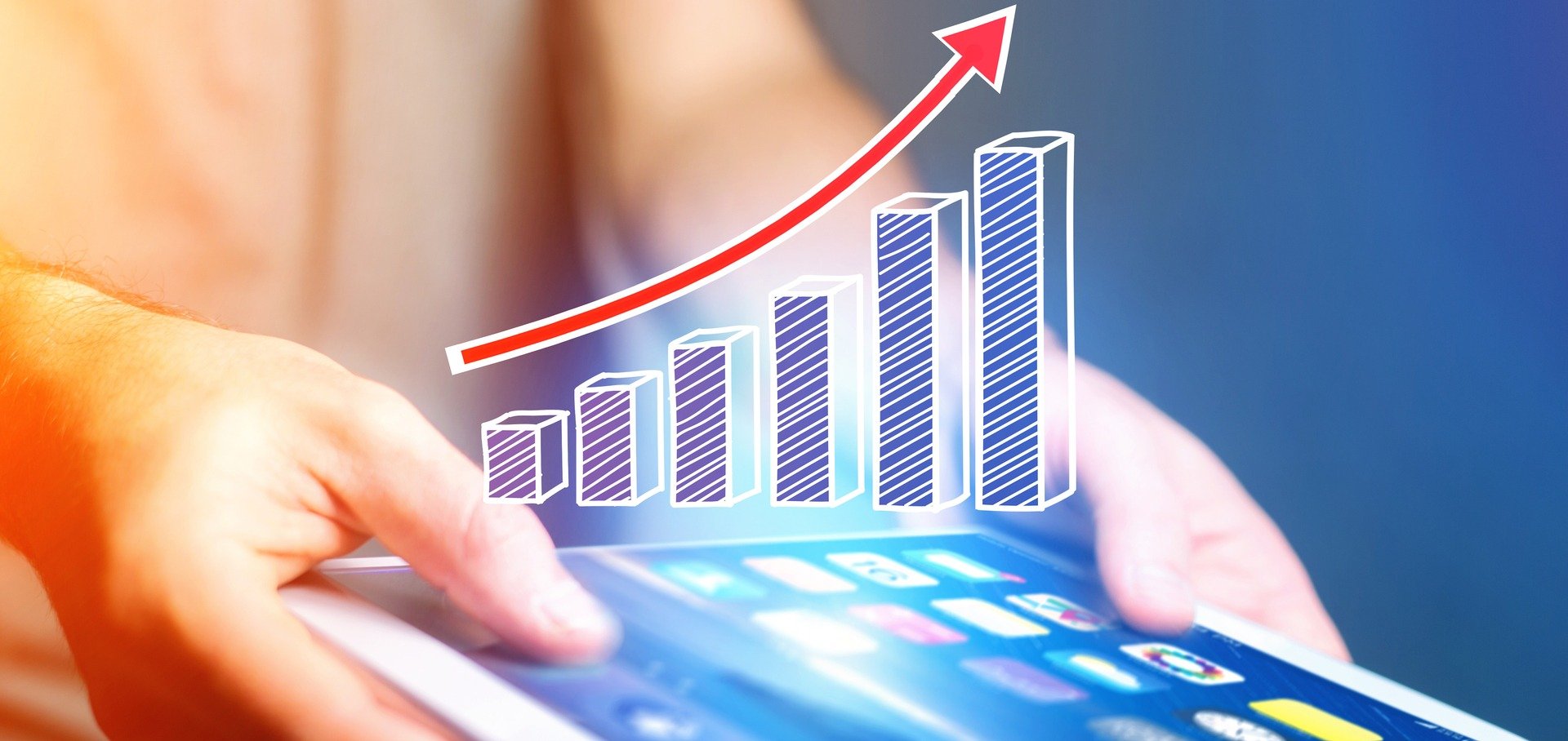 Both hands holding an ipad and a bar graph with its arrow increasing proportionally is displayed on the screen