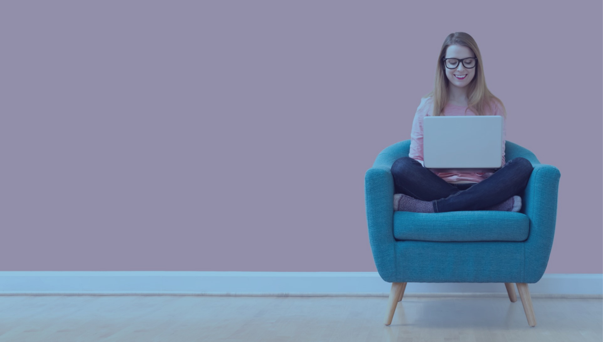 Woman sits with her legs crossed using laptop