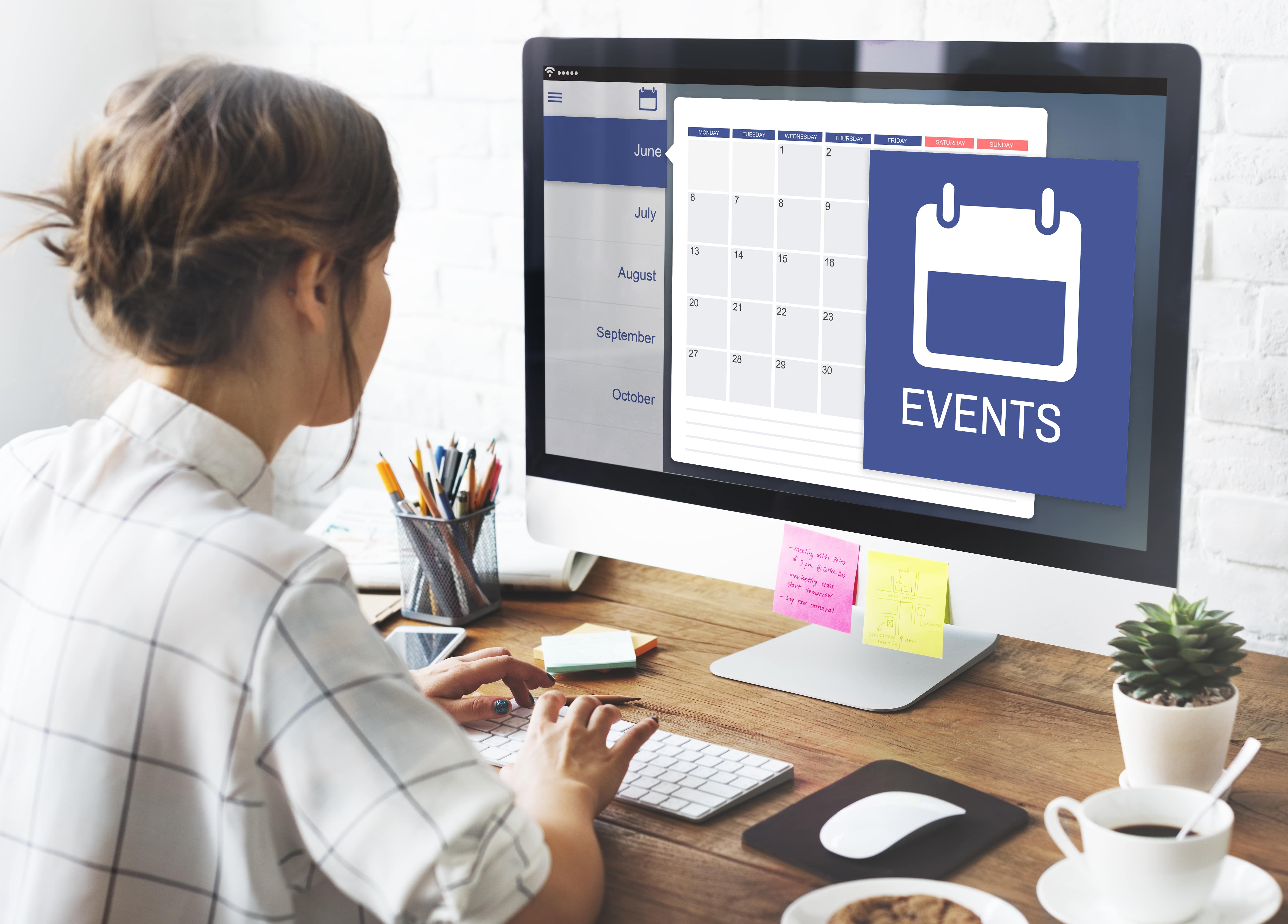 Woman at work planning work and scheduling meetings