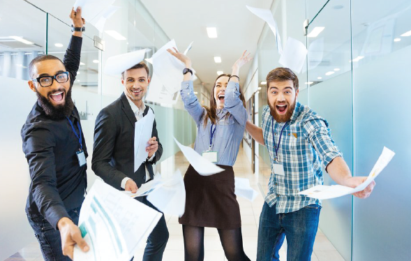 4 young adults seem excited and offer documents in office building