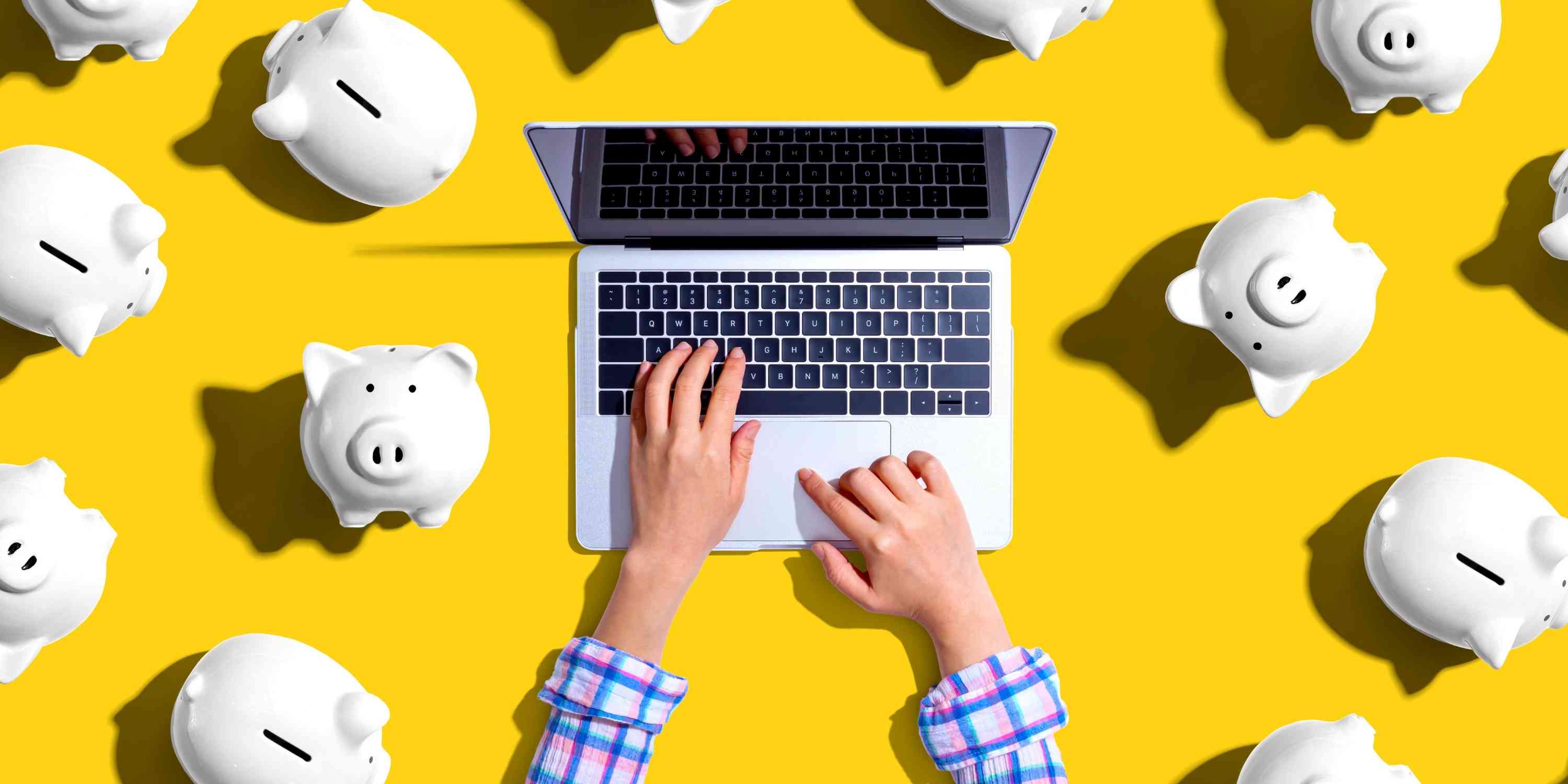 Customer uses laptop surrounded by piggy banks