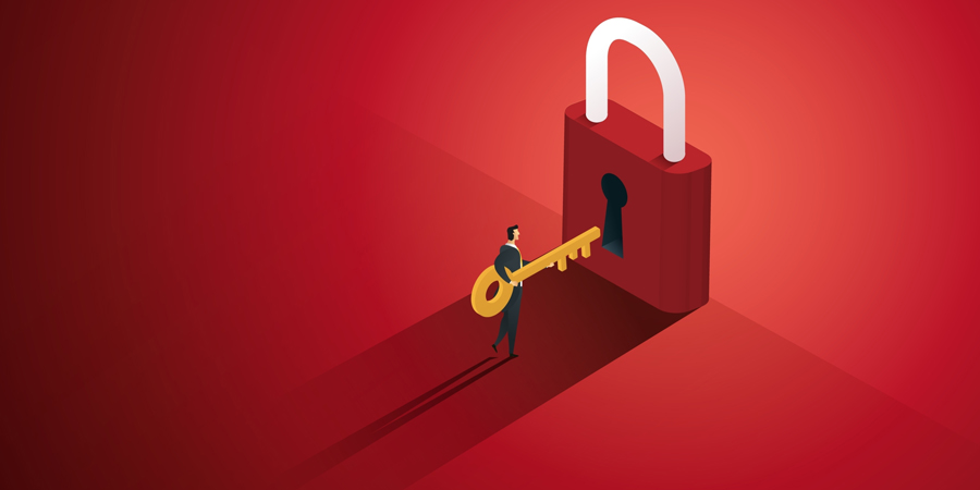 Business person opens giant red lock with gold key