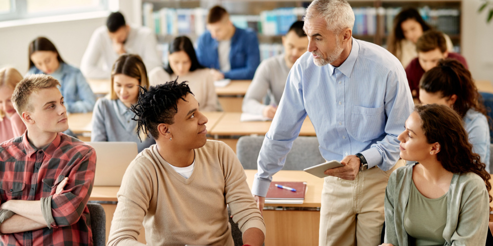 Professor with a tablet discussing something with a student.