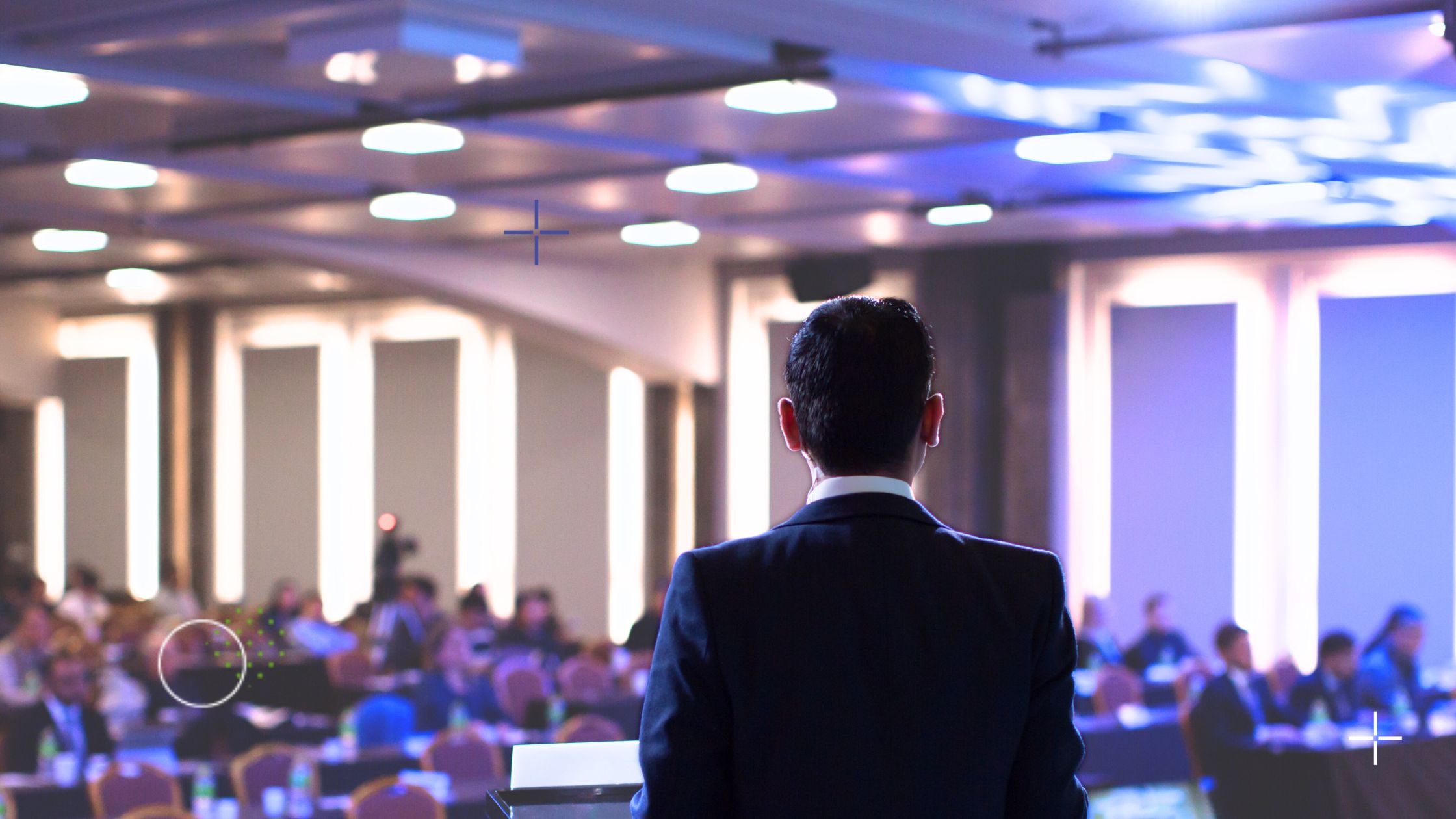 Man speaking to a full room at a conference