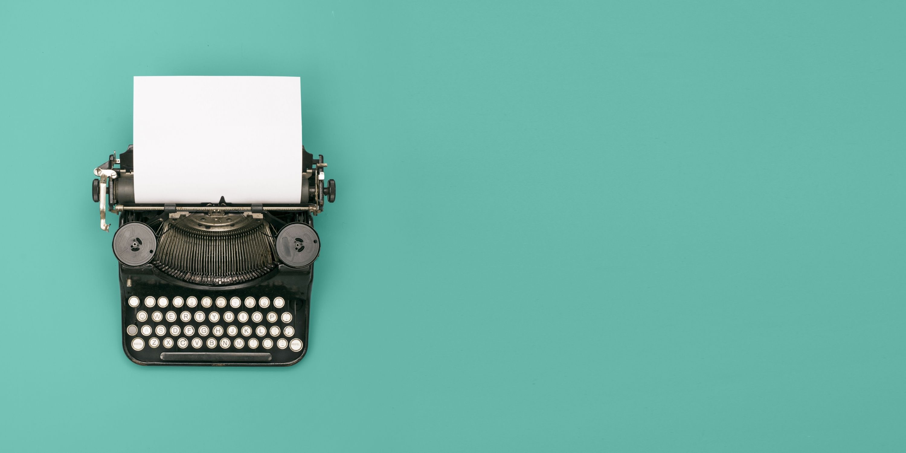 Typewriter with a blank piece of paper  on a teal background