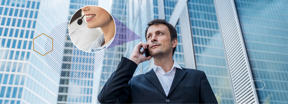 Man holding cell phone to his ear, talking to a customer service representative with high rise building in the background.. 